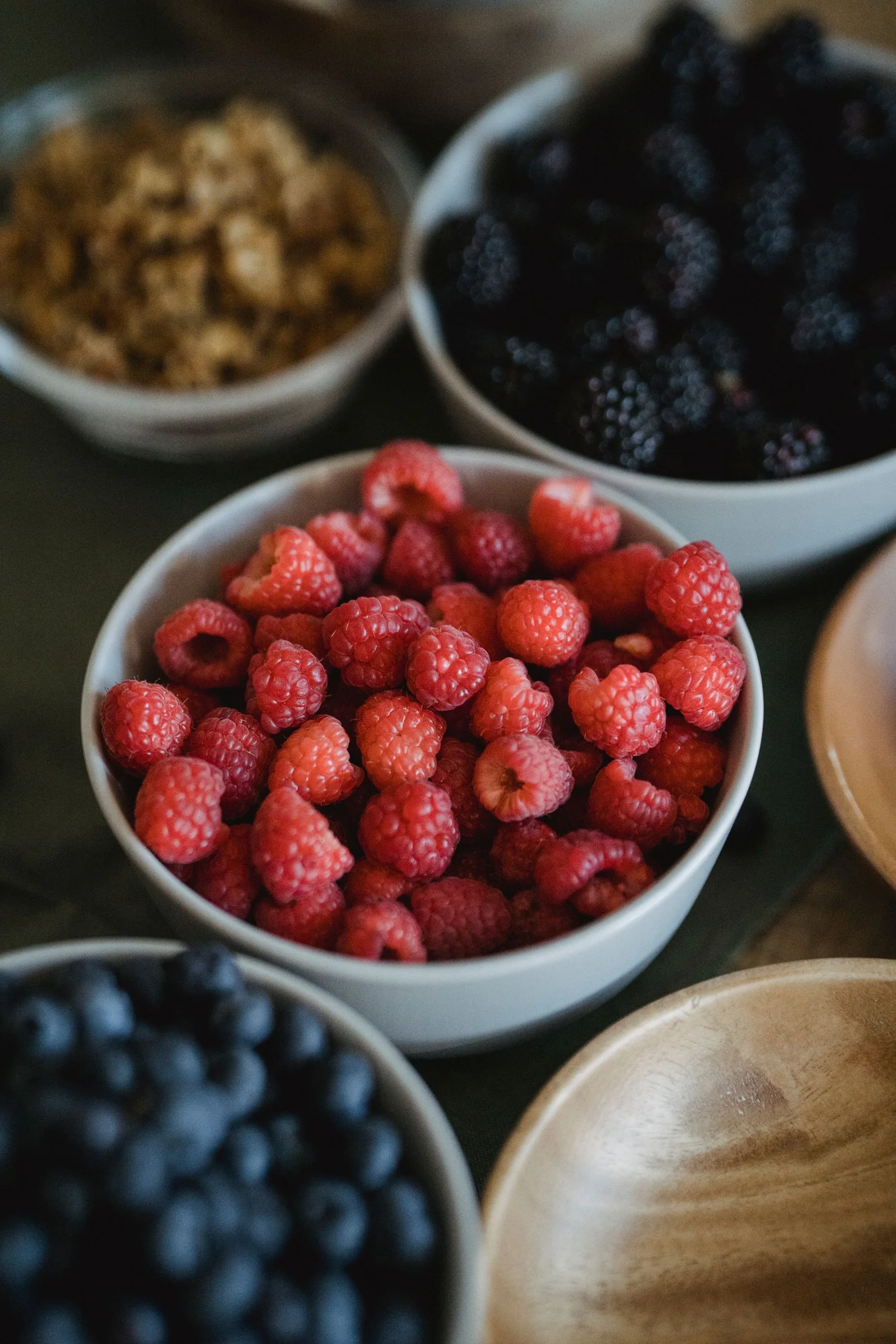 Raspberries, blackberries and blueberries in bowls